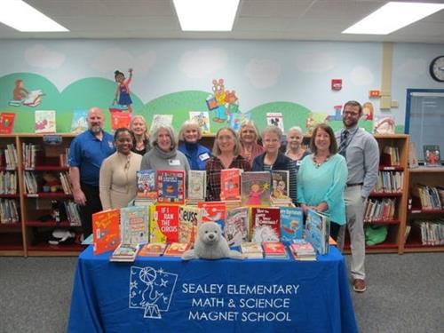 Friends, former colleagues and students of Dr. Sharon Hartman donated over 300 new books to the Sealey Elementary Math & Scie 